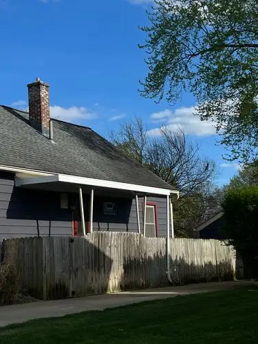 Sunny skies embrace a peaceful neighborhood home.
